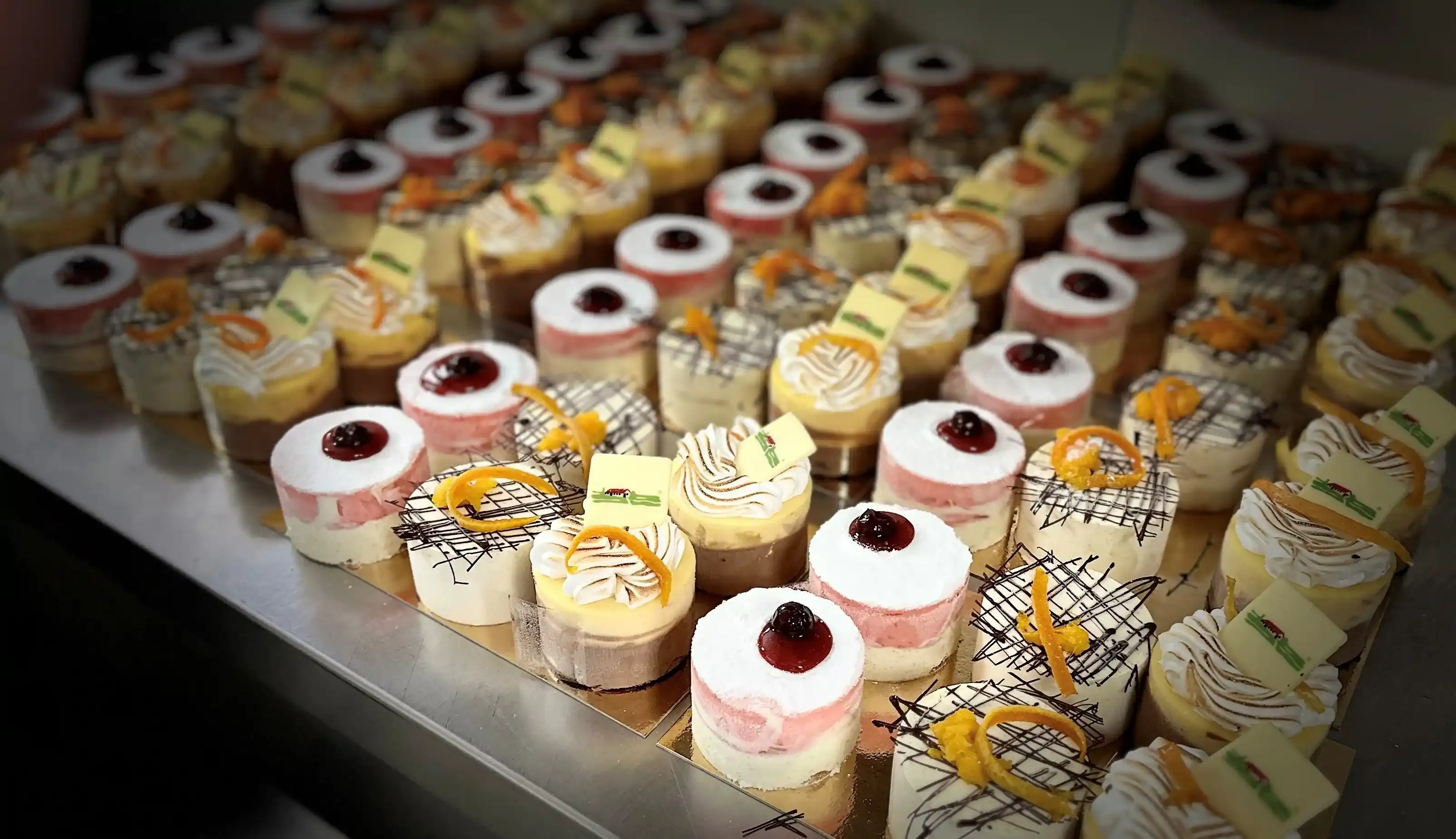 A collection of desserts organized neatly on a table.
